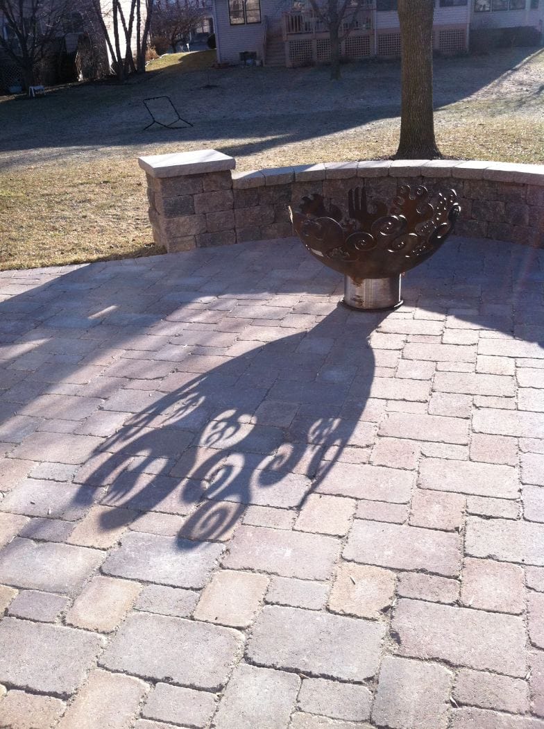 Fire Sculptural Fire Pit and shadow on pavers